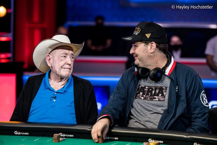 Doyle Brunson and Phil Hellmuth staring at each other during a WSOP event
